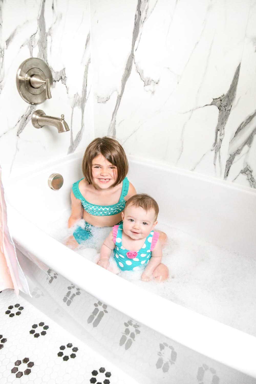 Whimsical, classic kids bathroom makeover | faux marble shower walls from American Standard
