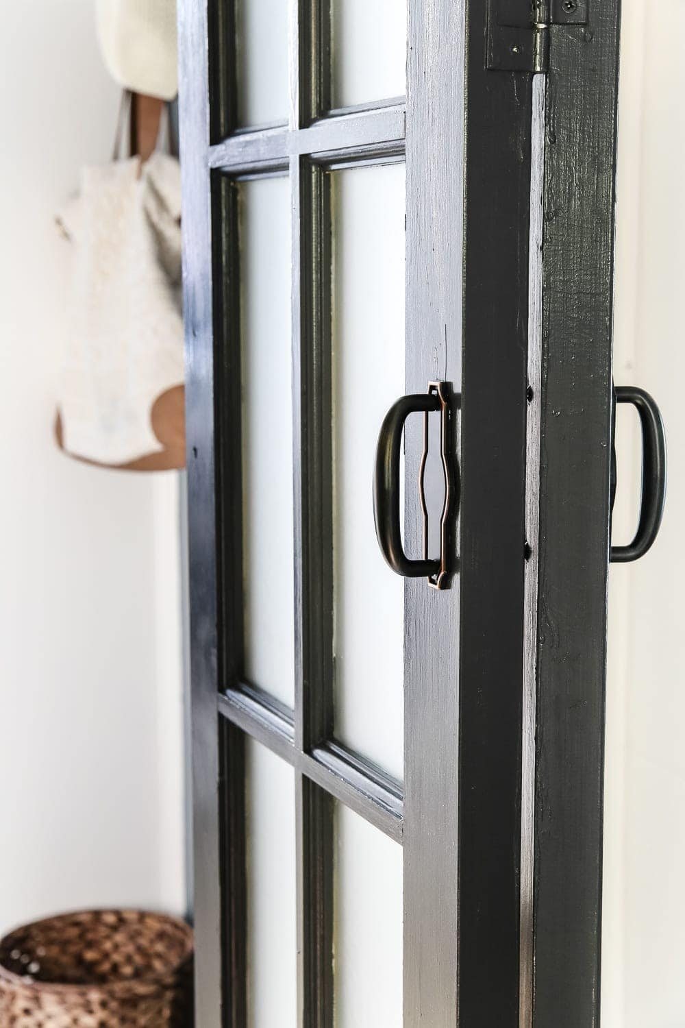 Laundry Room Updates: French Bifold Door | unigumushane.com - A rickity laundry room bifold door gets a beautiful and functional update with a French bifold door with frosted glass for hiding messes in a stylish way.