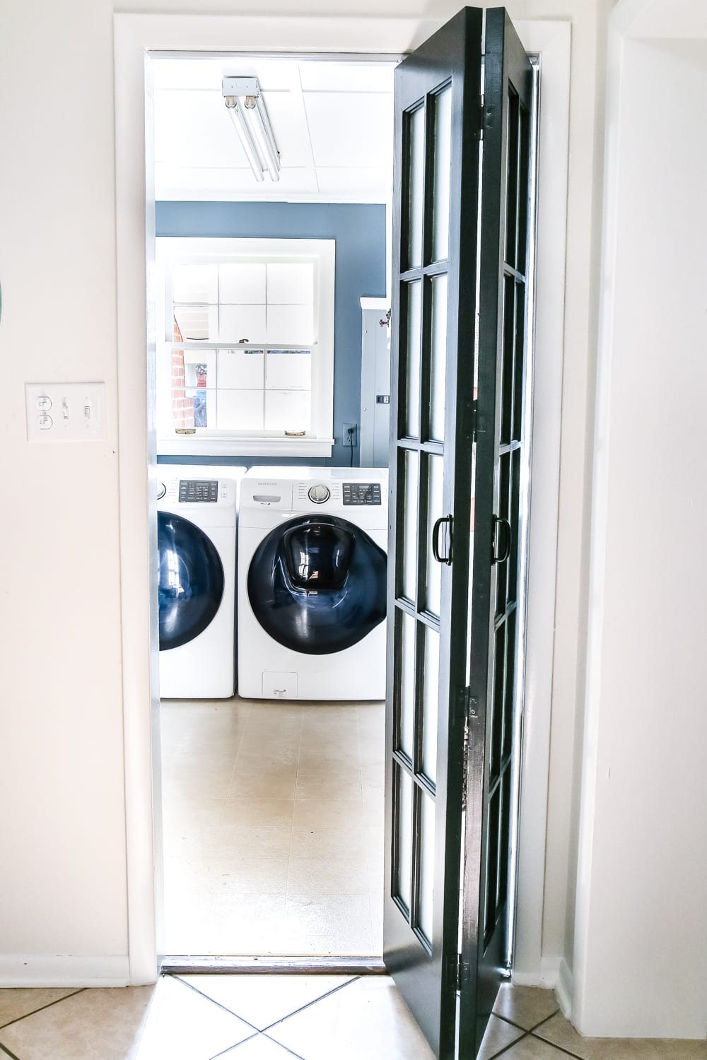 Laundry Room Updates: French Bifold Door | unigumushane.com - A rickity laundry room bifold door gets a beautiful and functional update with a French bifold door with frosted glass for hiding messes in a stylish way.