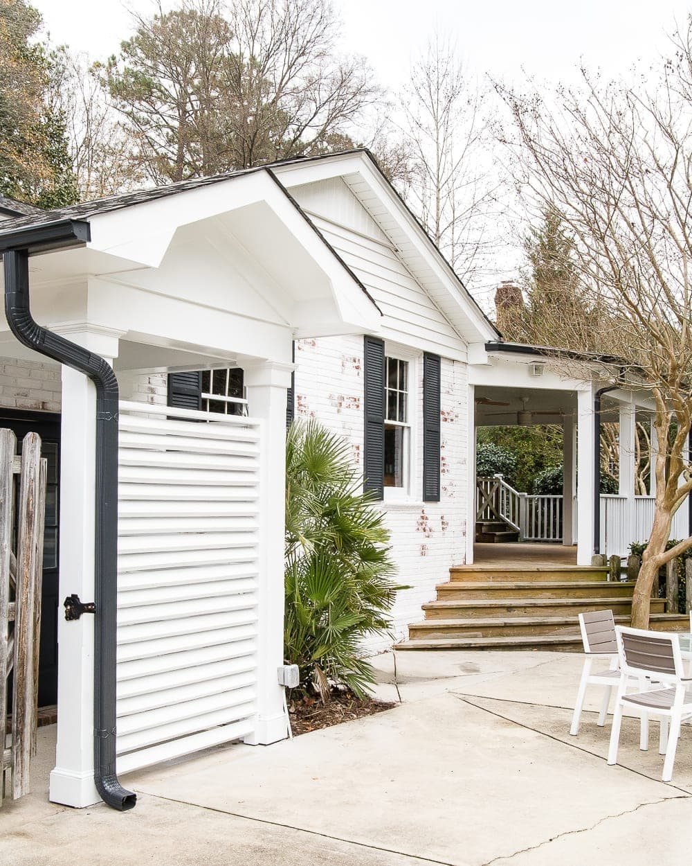 back house exterior with white brick and black shutters