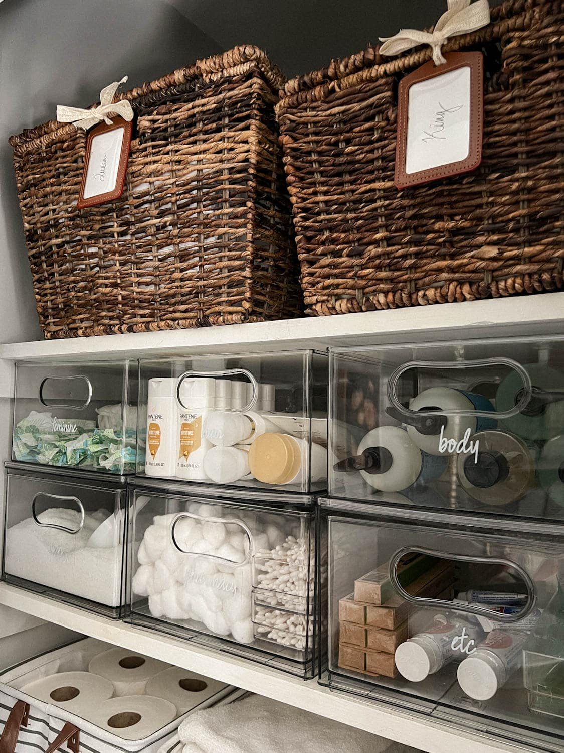 linen closet organization with drawers of soaps, medicine, and bath salts