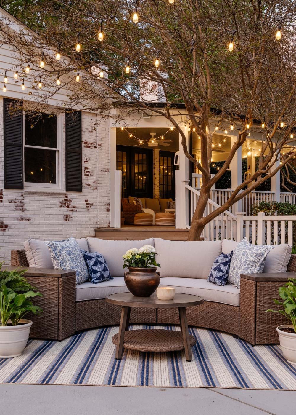 backyard furniture on patio with string lights