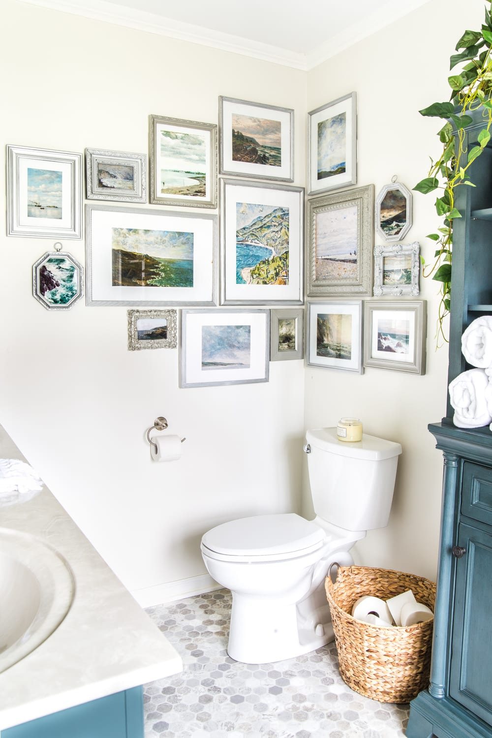 Budget Master Bathroom Refresh Reveal | corner gallery wall with thrifted frames and free coastal art printables
