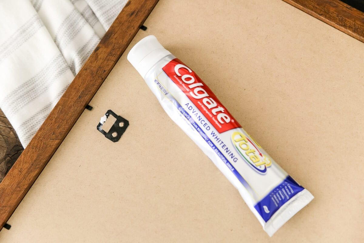 toothpaste trick to hang pictures