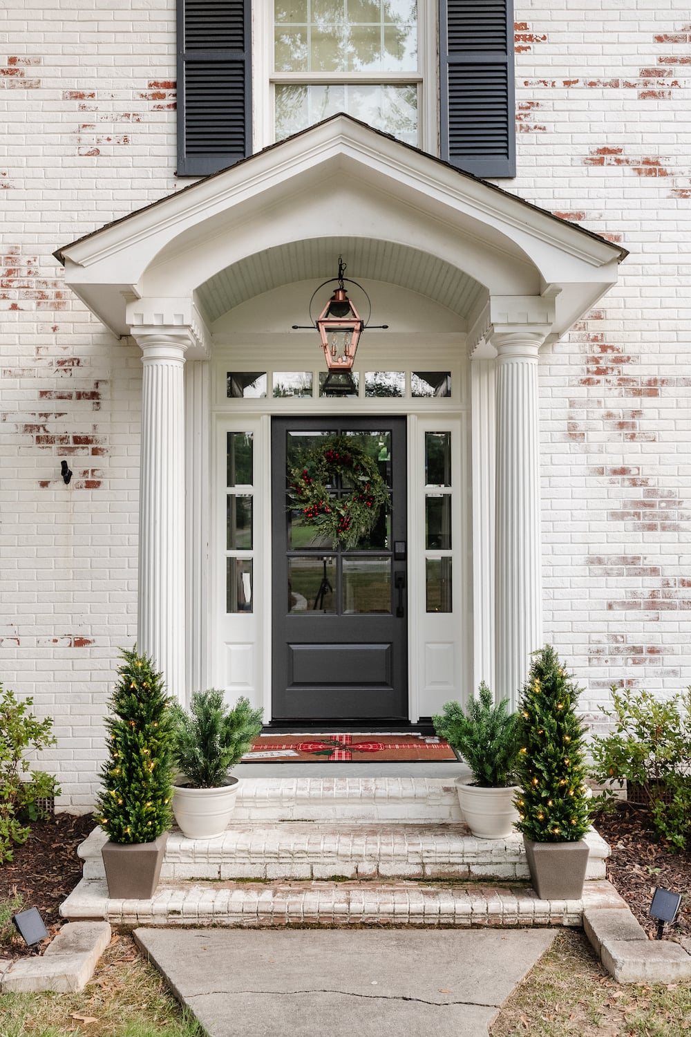 colonial porch stoop with Christmas wreath