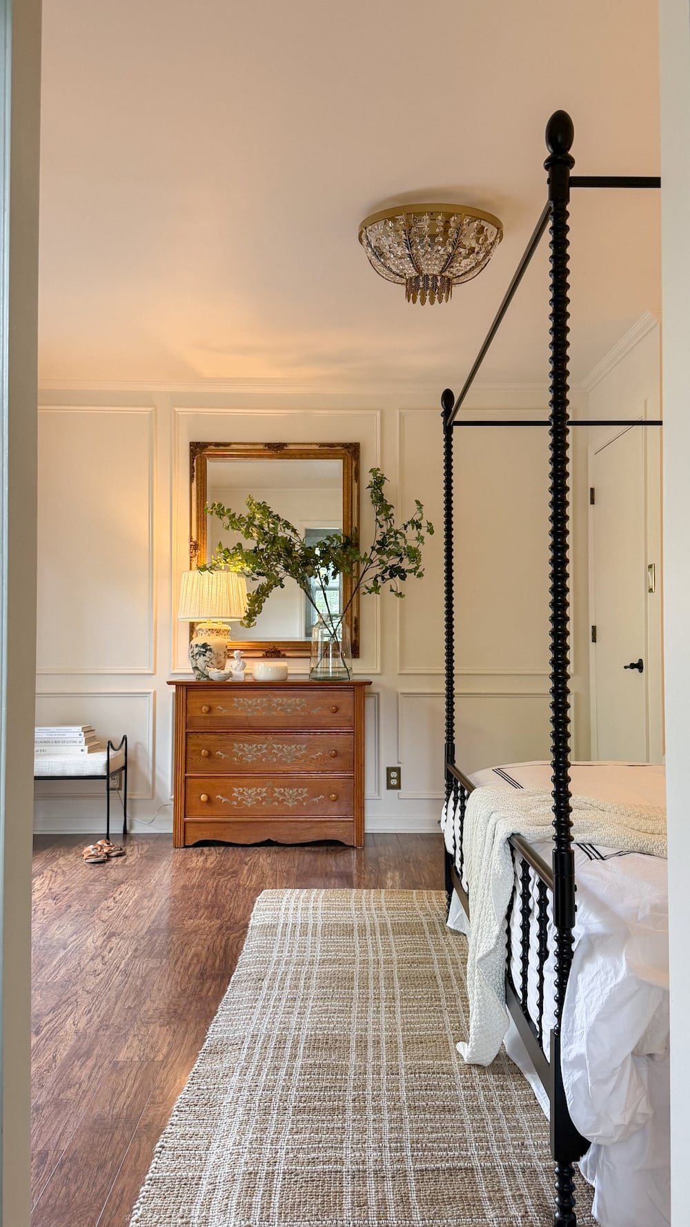 classic modern french country bedroom with layered lighting and canopy bed