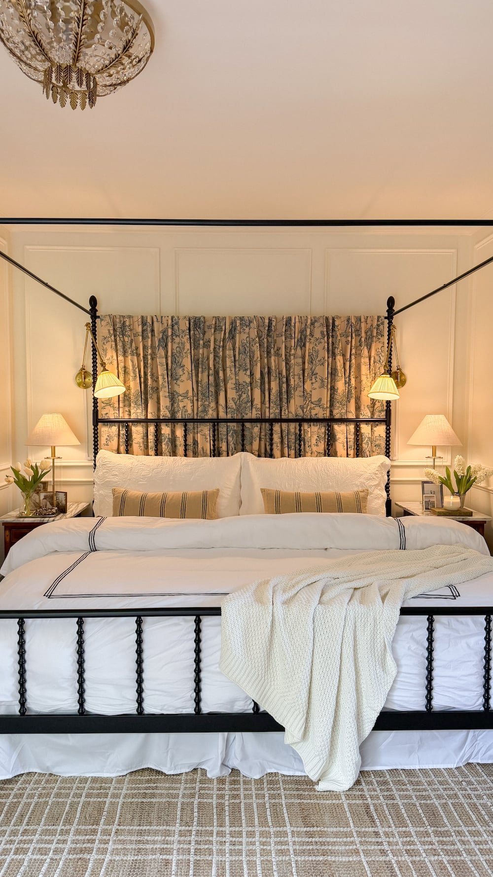 classic modern french country bedroom with layered lighting and canopy bed