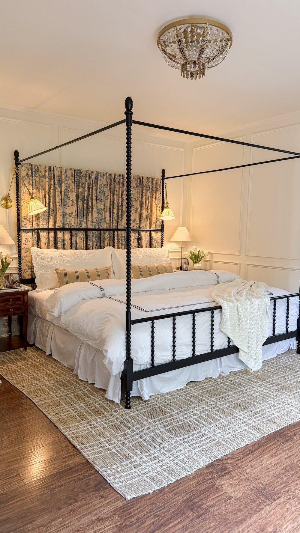 classic modern french country bedroom with layered lighting and canopy bed