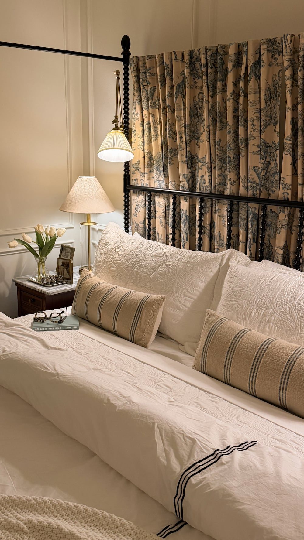 classic modern french country bedroom with layered lighting and canopy bed