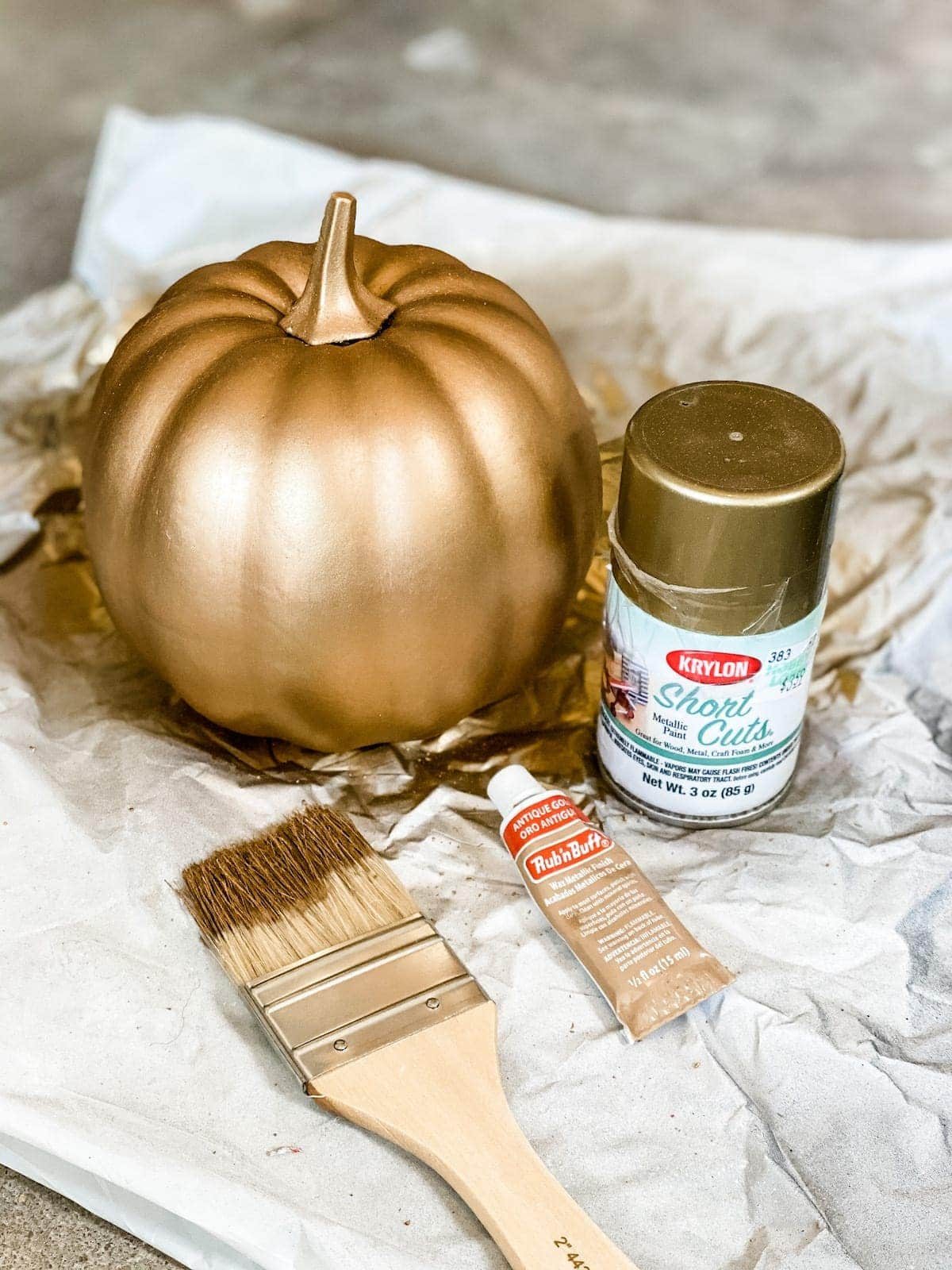fake pumpkin painted to look like aged brass