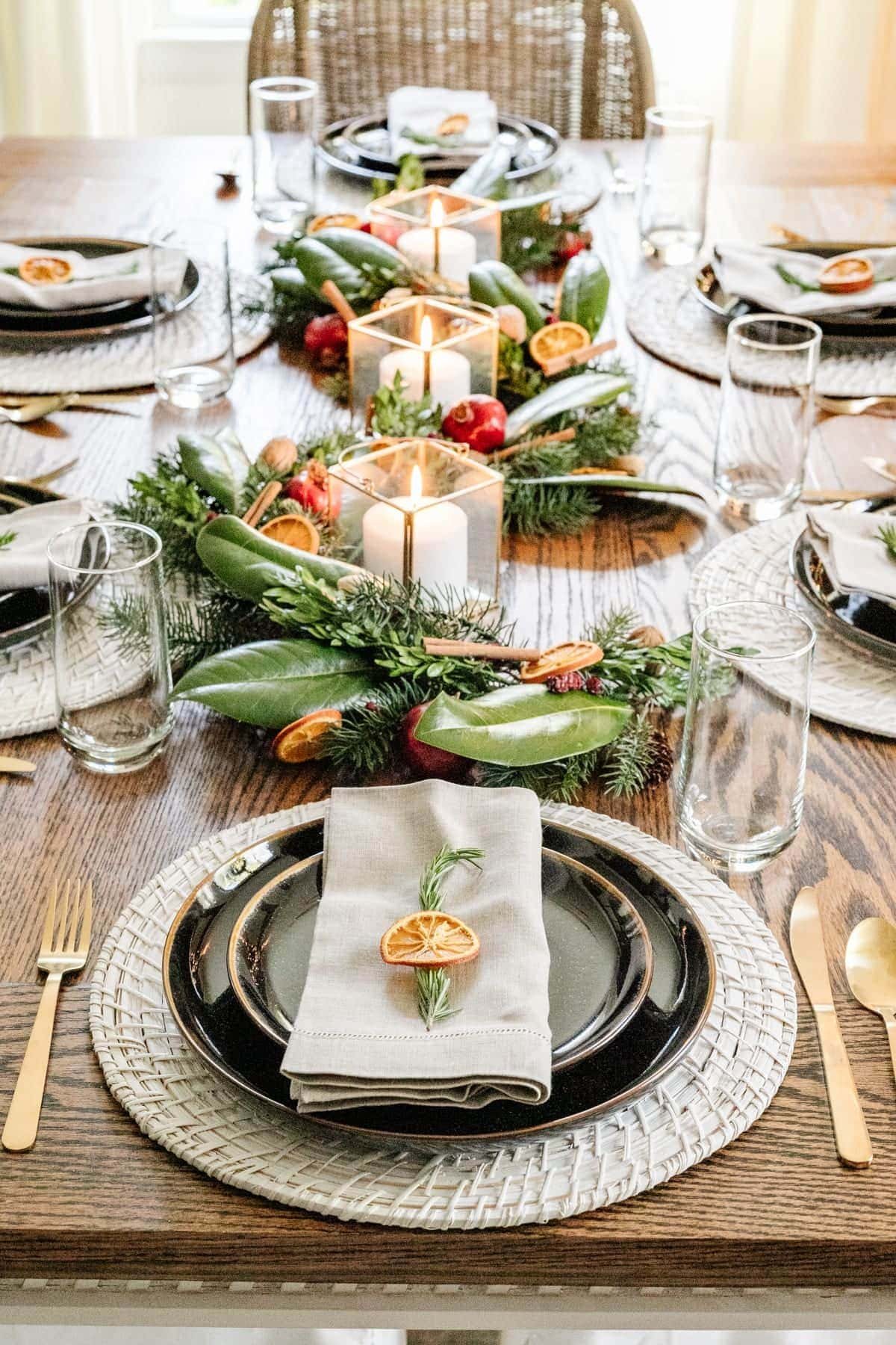 Christmas table centerpiece with fresh leaves and dried citrus