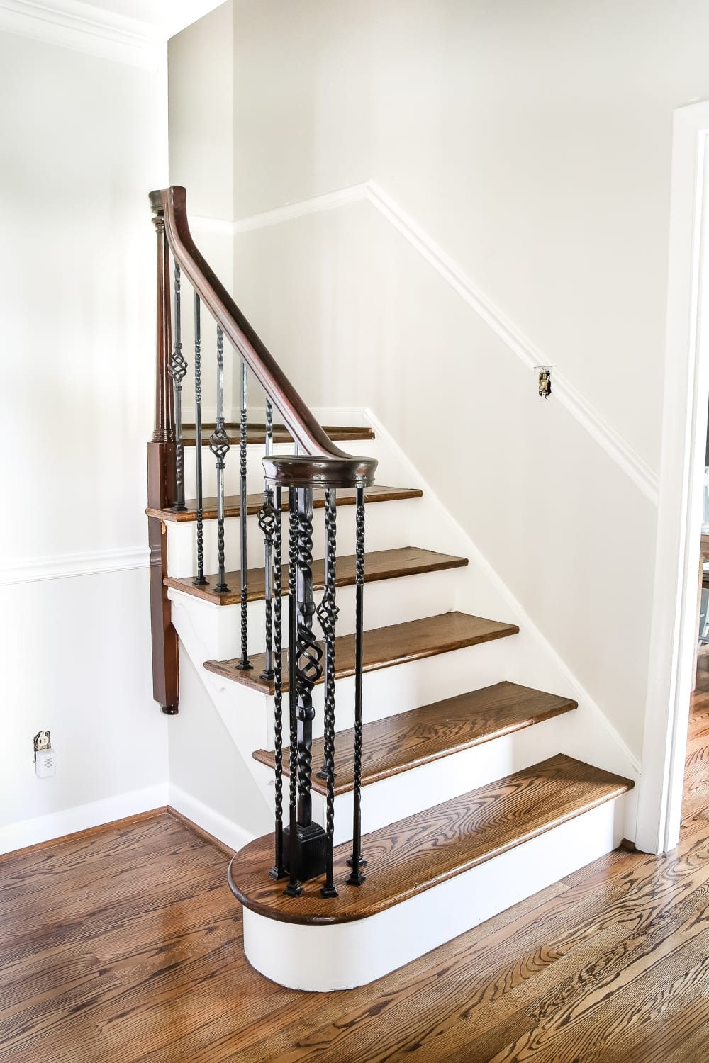 Neutral Painted Foyer Update | unigumushane.com - A drab, dated foyer and staircase get a bright, neutral facelift with high contrast details using Benjamin Moore colors Classic Gray and Wrought Iron.