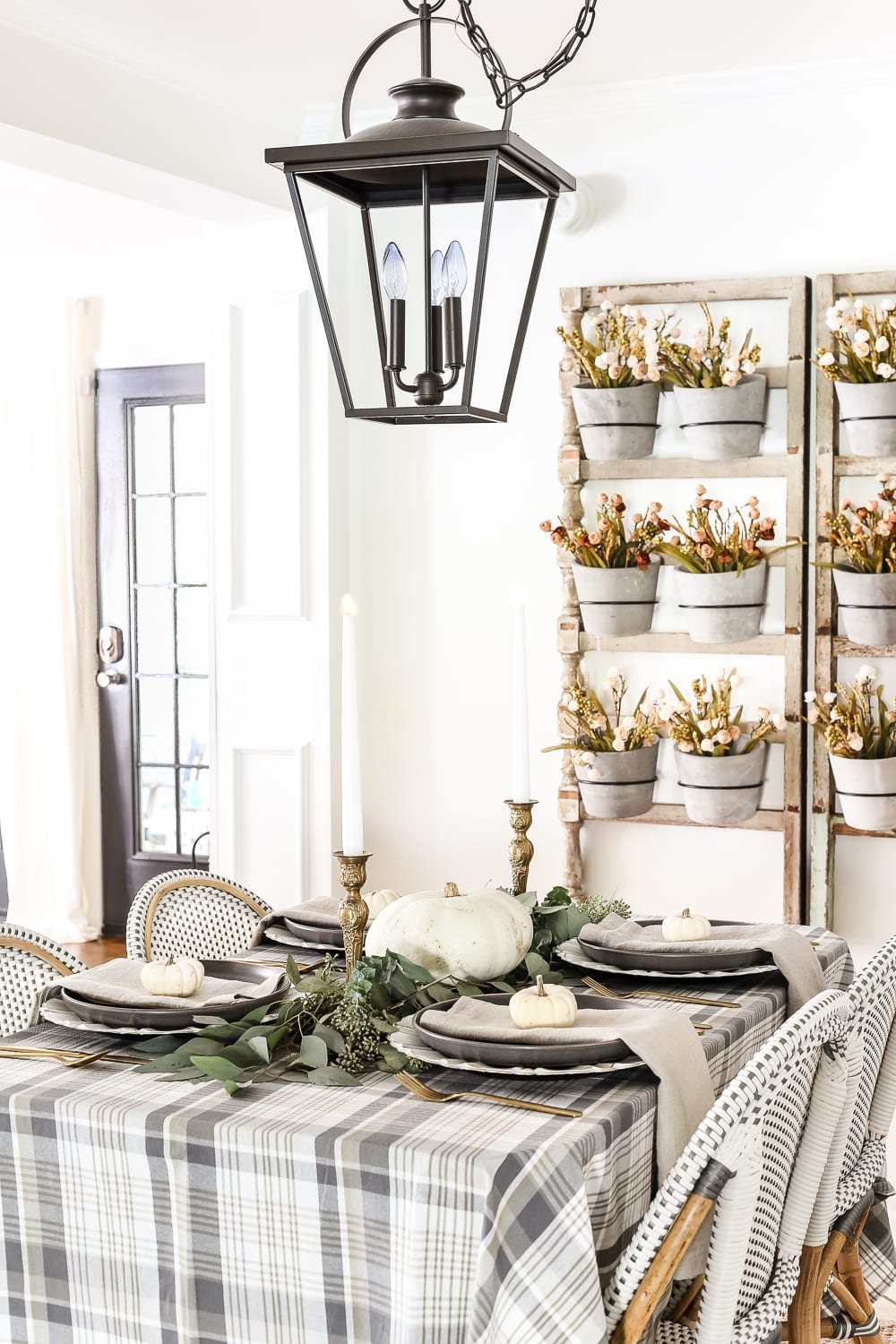 Neutral Low-Key Thanksgiving Tablescape | unigumushane.com - A neutral low-key Thanksgiving tablescape that is simple and inexpensive to recreate using plaid fabric, white pumpkins, eucalyptus, and brass.