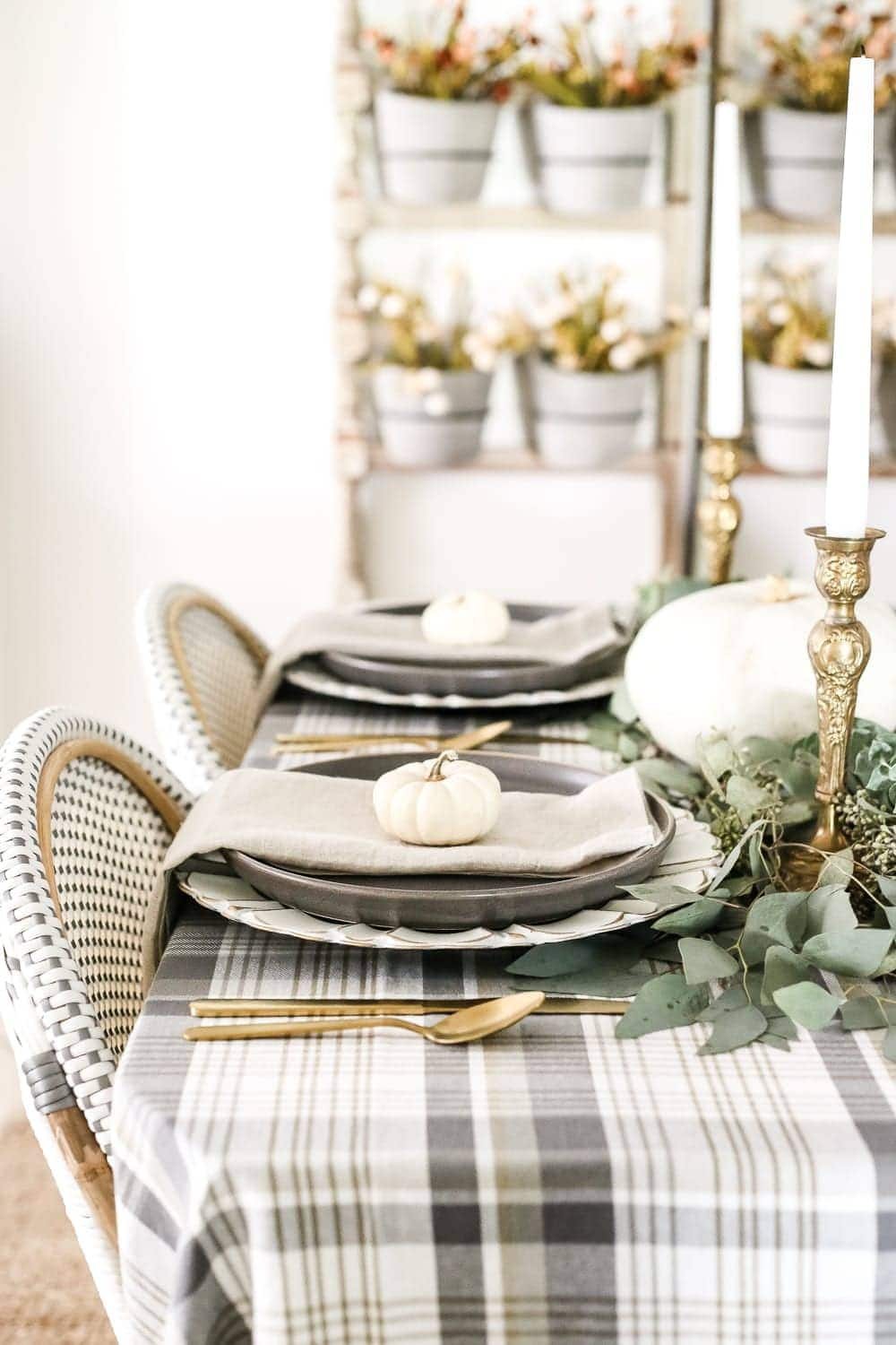 Neutral Low-Key Thanksgiving Tablescape | unigumushane.com - A neutral low-key Thanksgiving tablescape that is simple and inexpensive to recreate using plaid fabric, white pumpkins, eucalyptus, and brass.