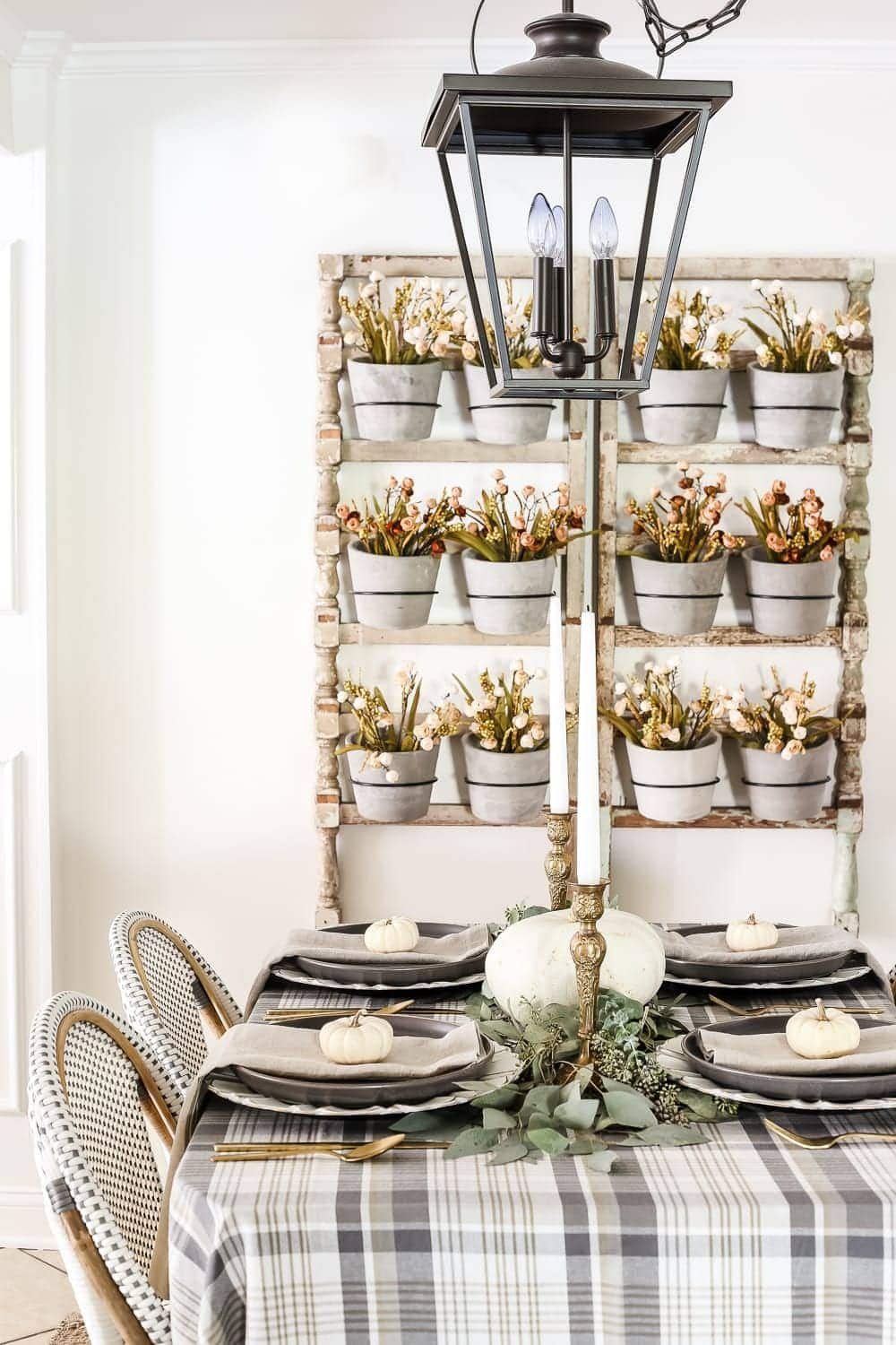 Neutral Low-Key Thanksgiving Tablescape | unigumushane.com - A neutral low-key Thanksgiving tablescape that is simple and inexpensive to recreate using plaid fabric, white pumpkins, eucalyptus, and brass.