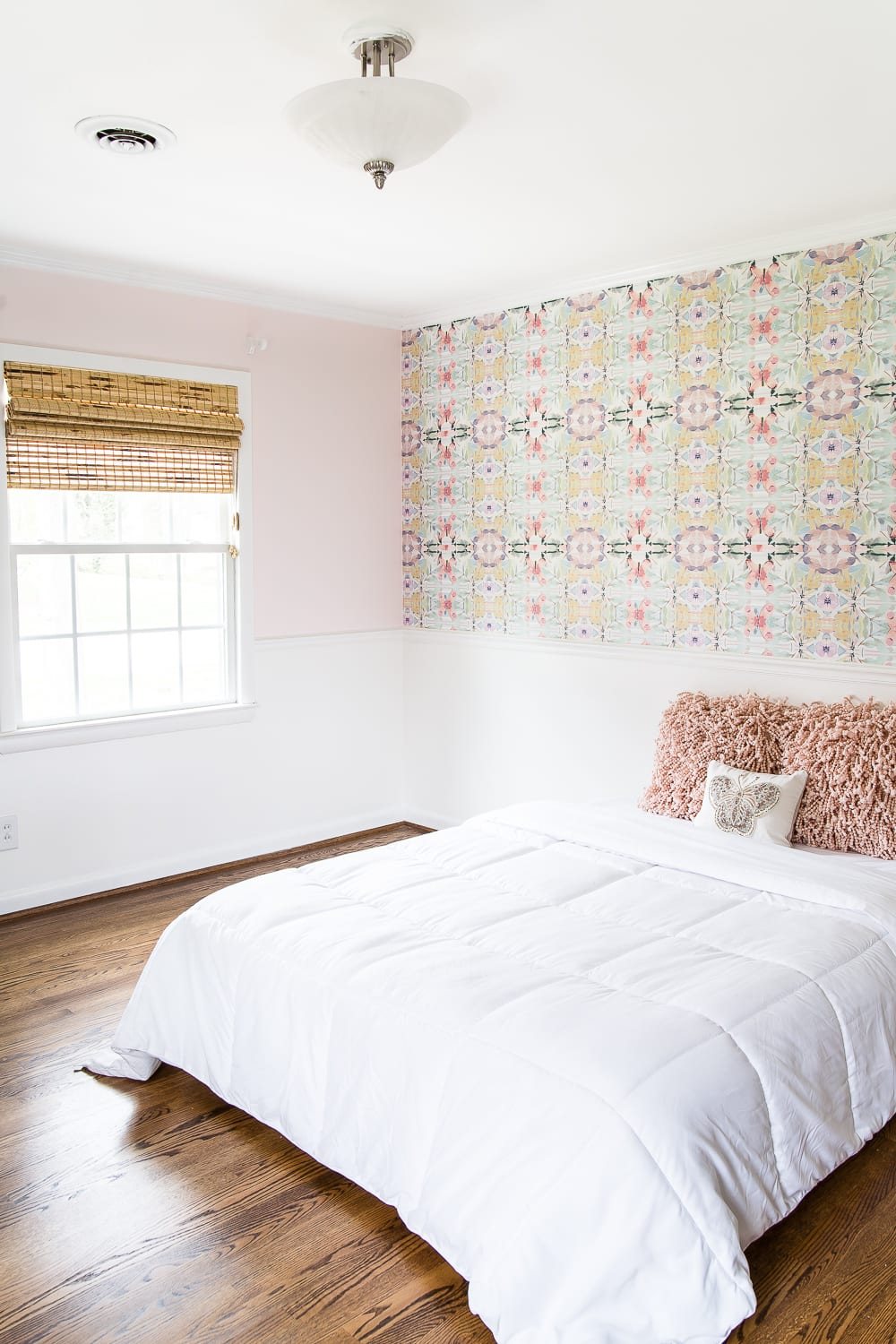 A sweet pastel little girl bedroom makeover with Behr My Sweetheart and retro wallpaper to transition into pre-teen/teenage years. #girlbedroom #kidsdecor #wallpaper #pinkpaint