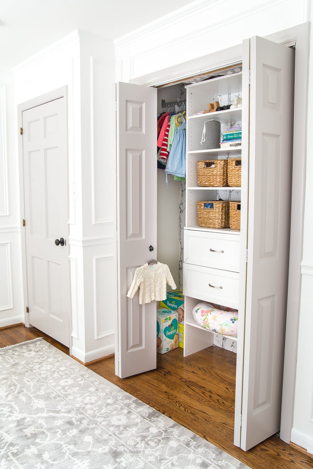A full organizational overhaul on a nursery closet that is packed full of functional storage solutions for baby, plus a free closet divider printable set.