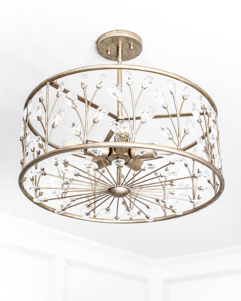 A feminine, vintage, glam lighting update for a baby girl's nursery makeover. #nurserylighting #lightfixture #glamdecor #vintagedecor