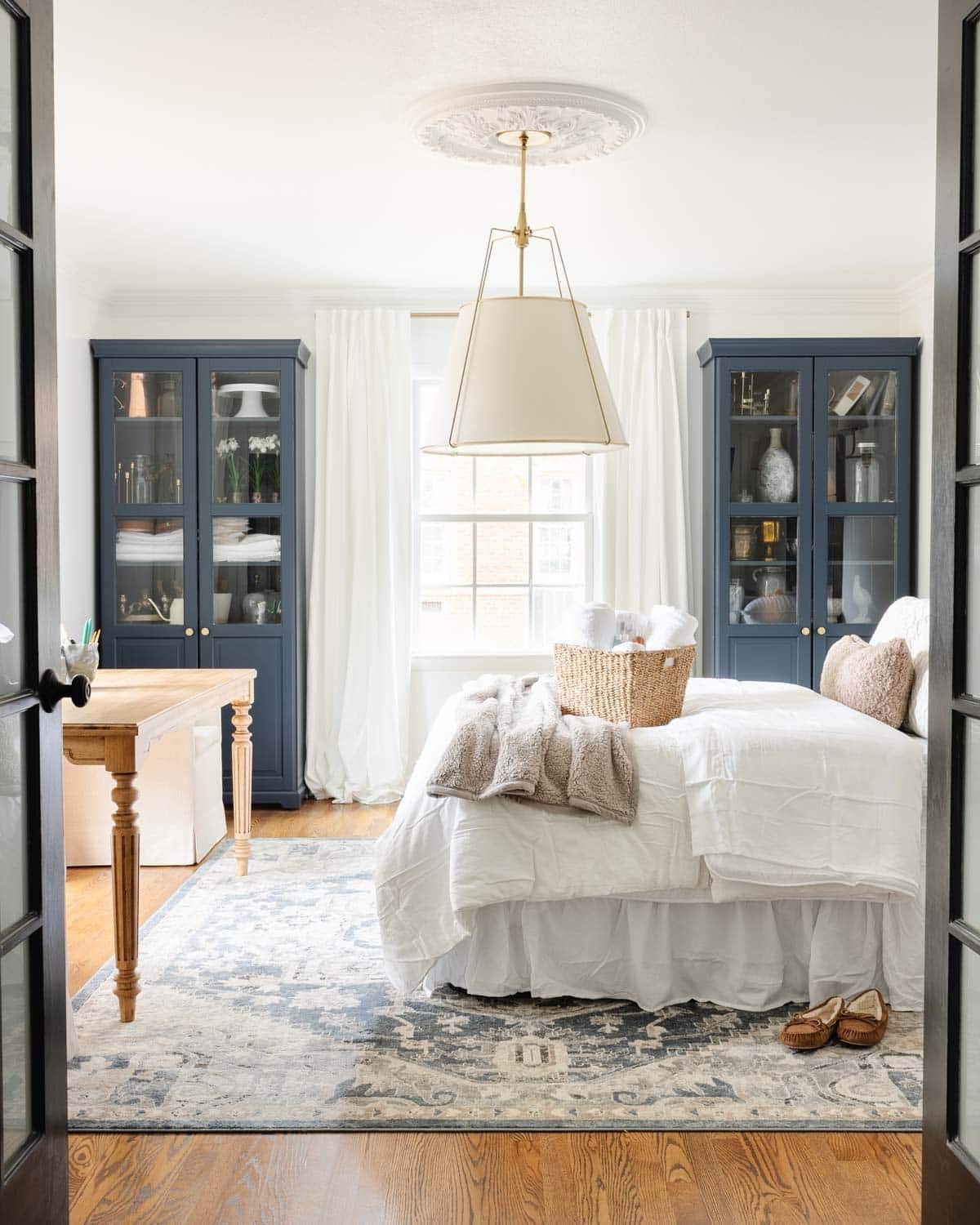 a home office set up as a temporary guest room and making an air mattress comfortable like a real bed