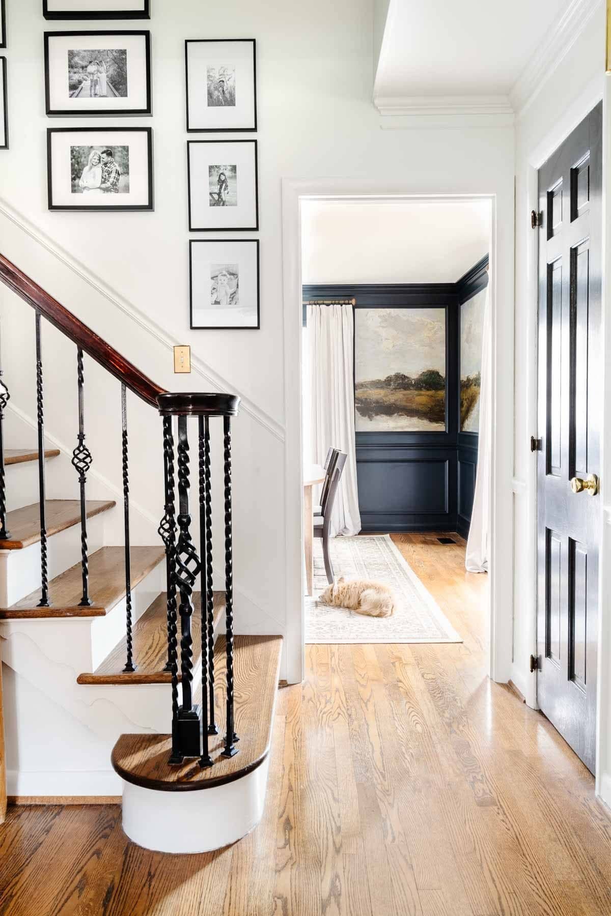stairway gallery wall with view leading into dining room with mural wallpaper