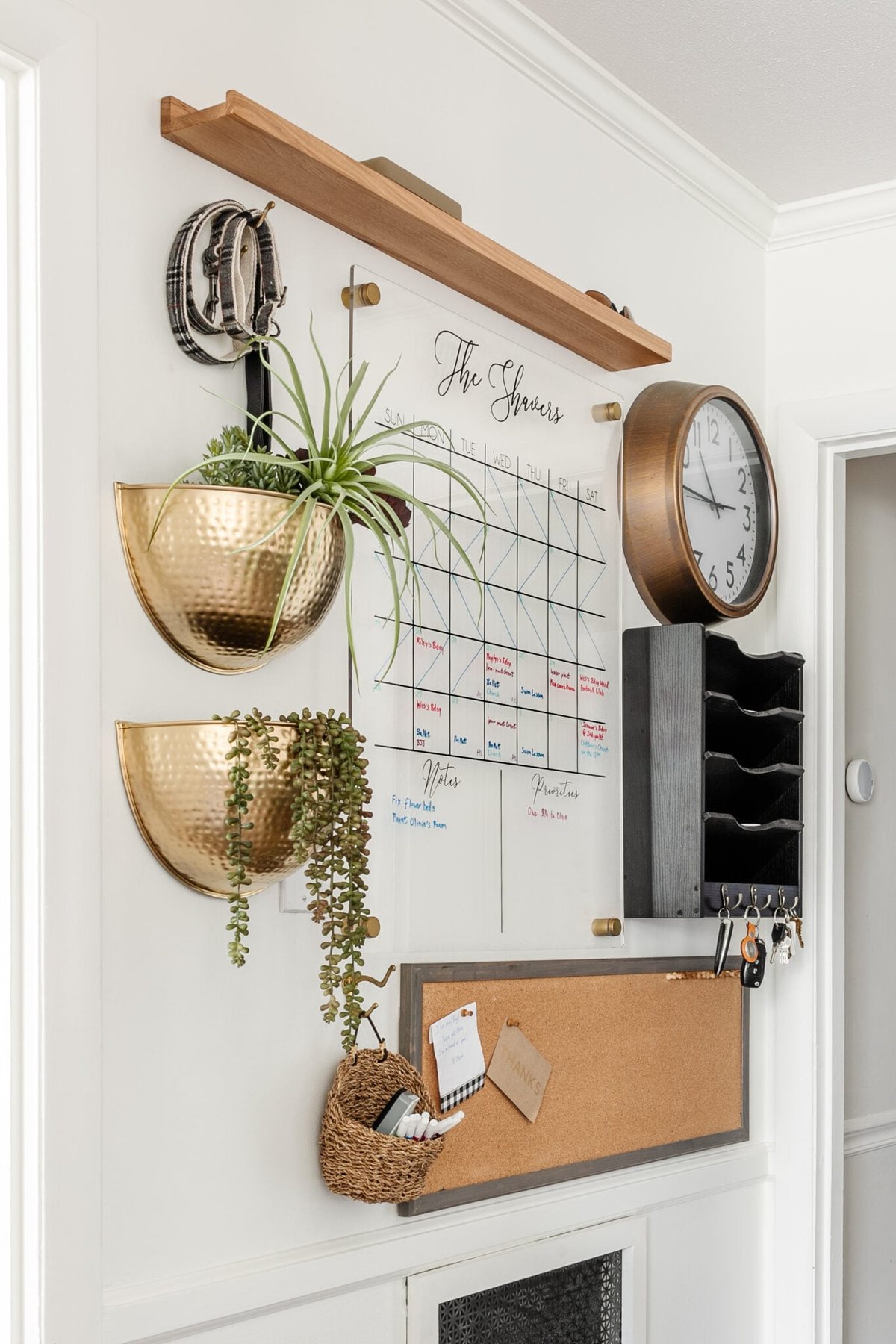 kitchen command center wall for family organization using calendar, mail sorter, key rack, and memo board