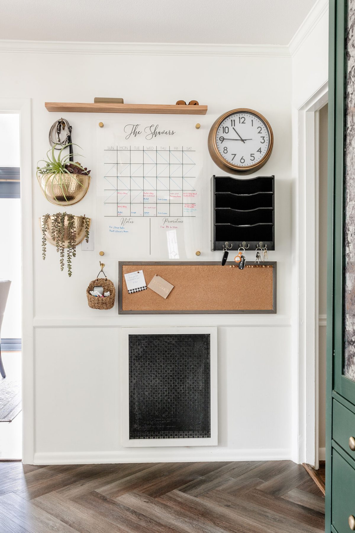 kitchen command center wall for family organization using calendar, mail sorter, key rack, and memo board