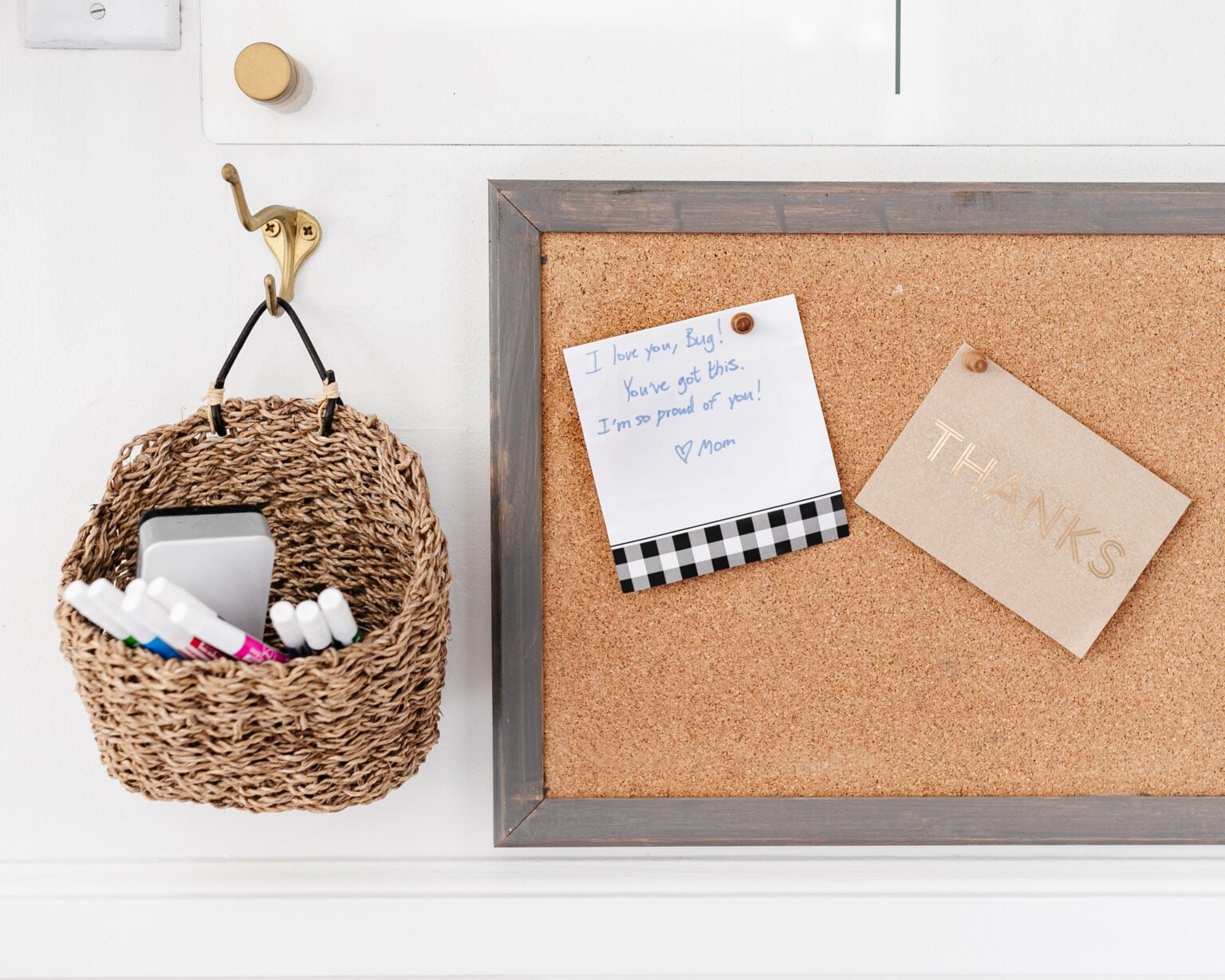 cork board and wall basket with dry erase markers