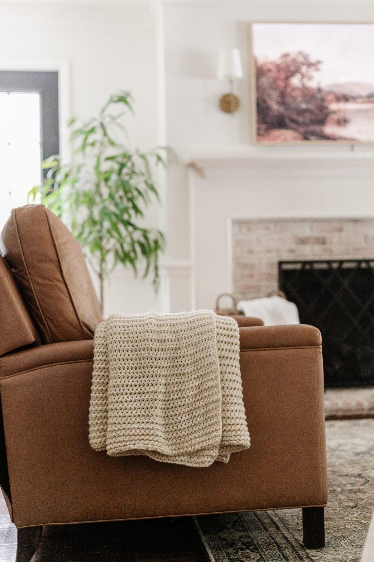 leather recliner with knit throw blanket in a living room for fall decor