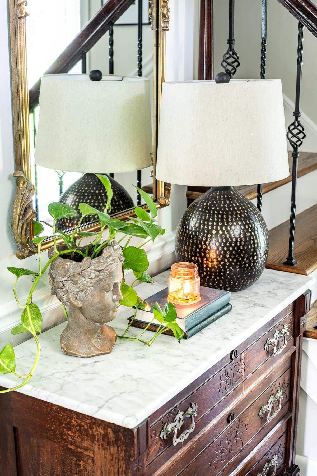 Classic timeless modern foyer - bust planter, table lamp, chest styling vignette
