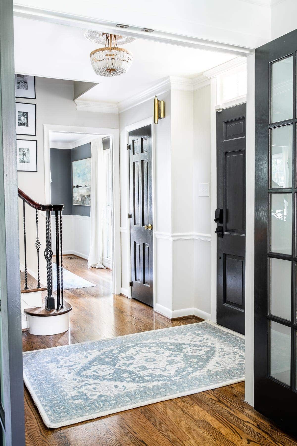 Classic timeless modern foyer with black doors