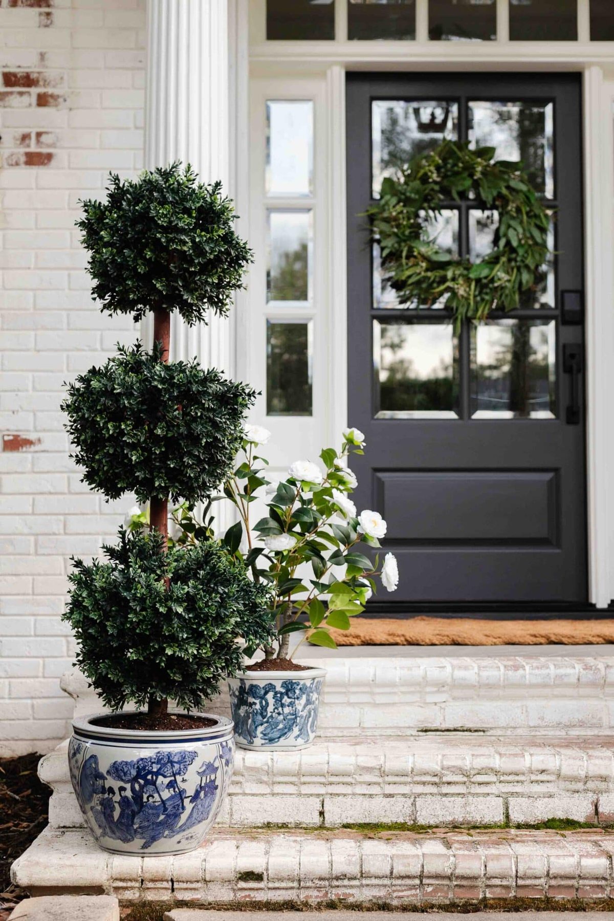 blue and white planters on porch steps