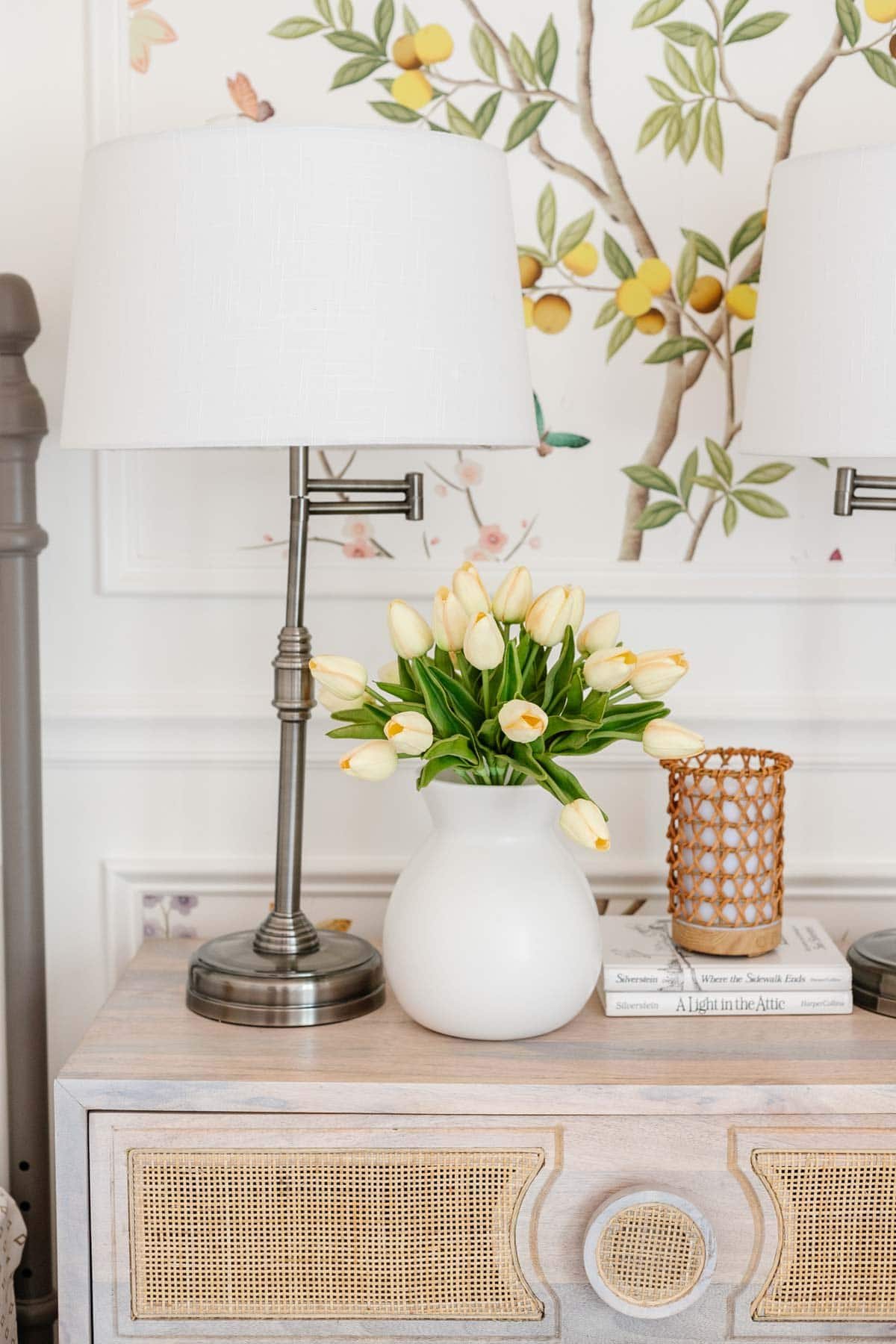 toddler girl room decor with faux flowers, lamp, and diffuser