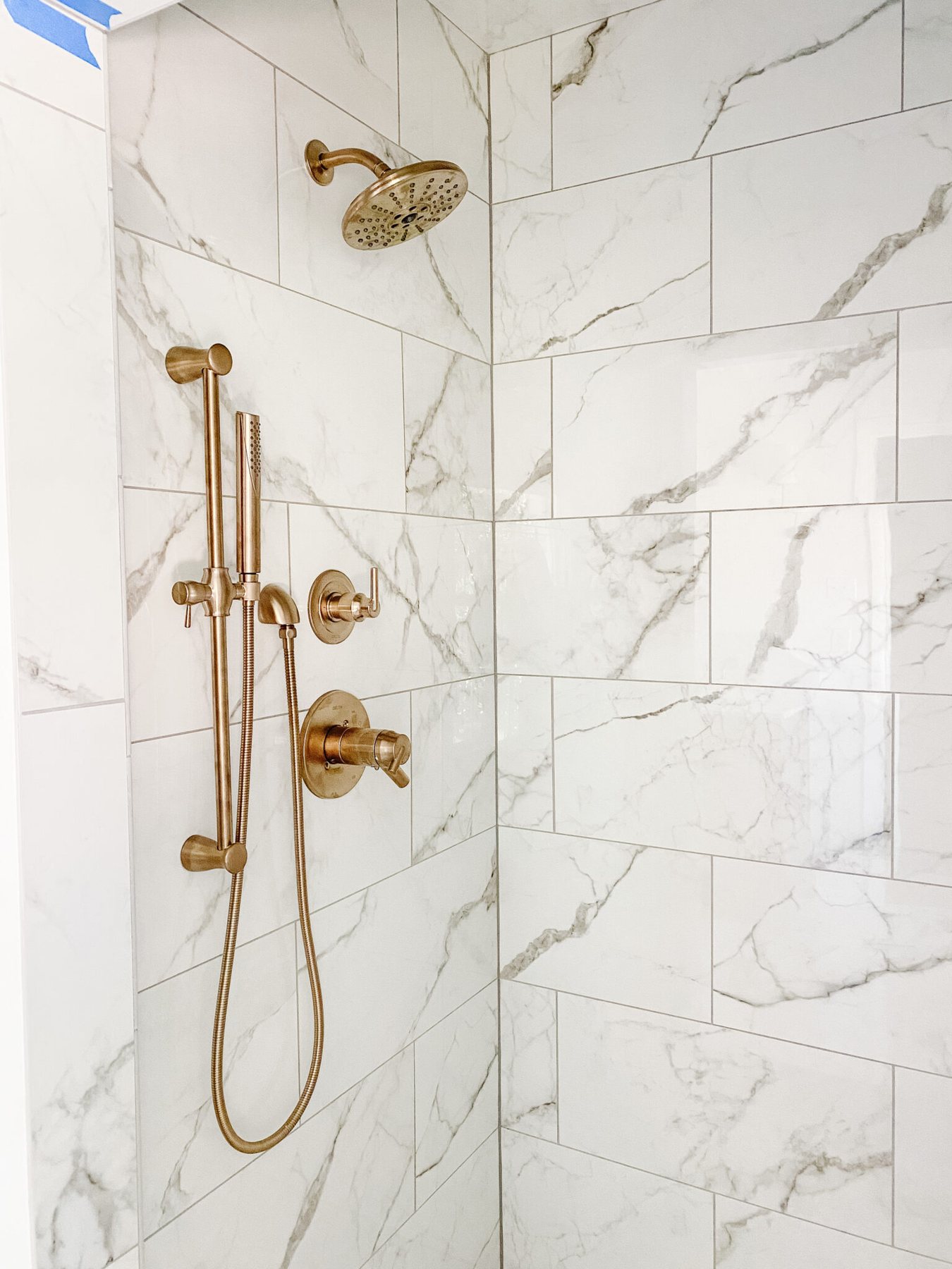 champagne bronze shower faucets in en suite bathroom