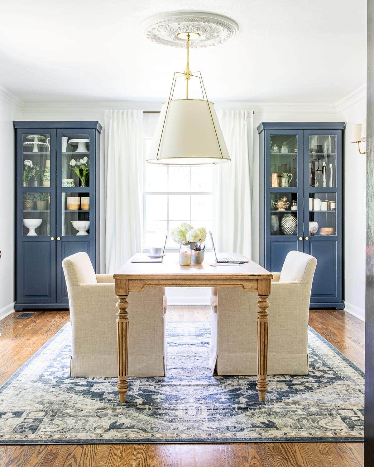 An outdated dining room gets converted to a light and bright home office with a timeless new look and functional storage.