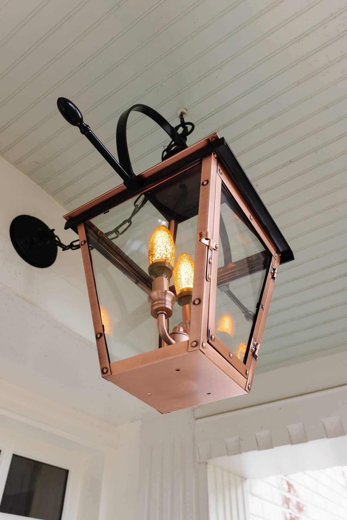 copper lantern fixture on a porch