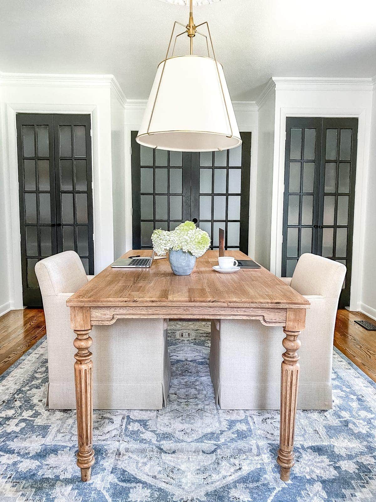 An outdated dining room gets converted to a light and bright home office with a timeless new look and functional storage.