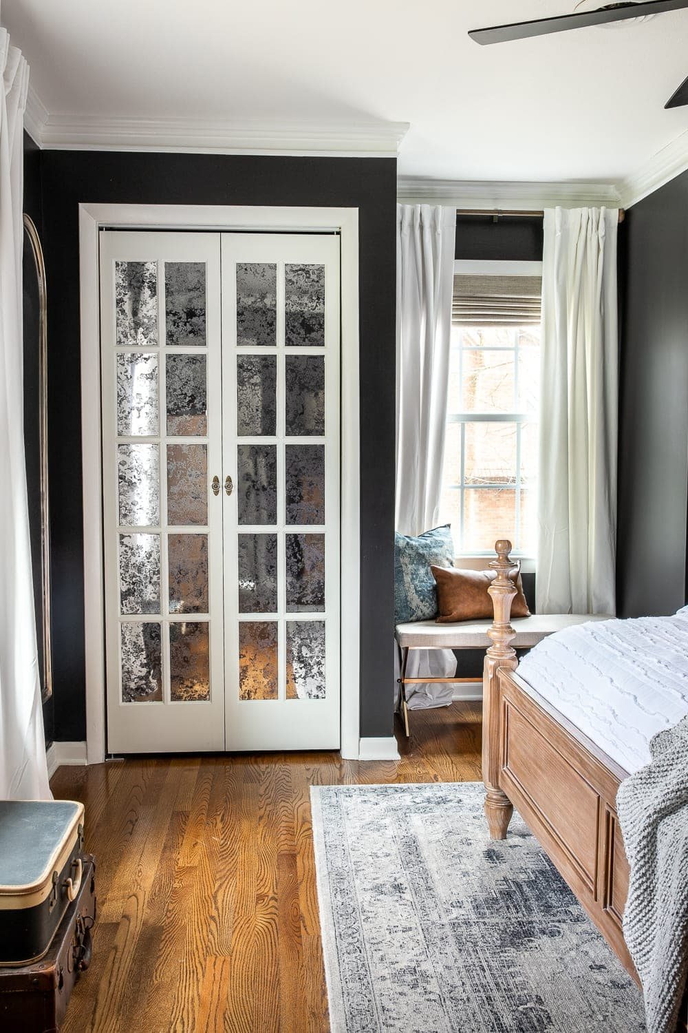 black master bedroom with French bifold closet doors