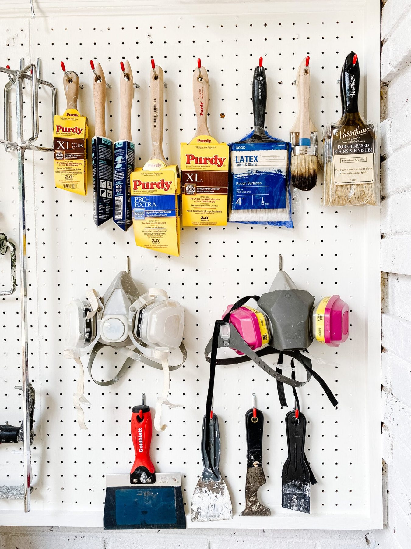 pegboard hooks with paint brushes