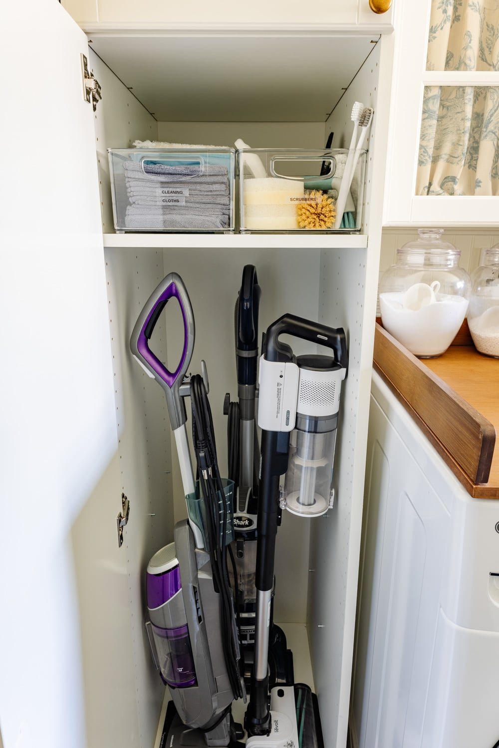 hidden diy broom cupboard and cleaning supply storage in a laundry room