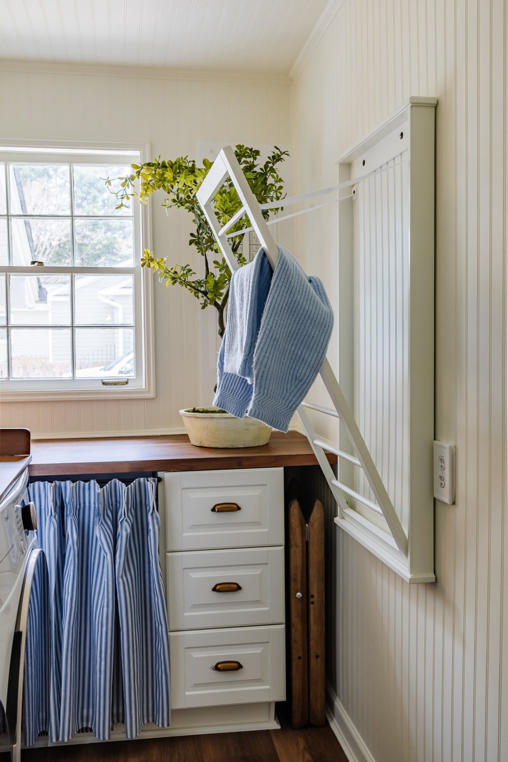 small laundry room organization - wall mounted drying rack