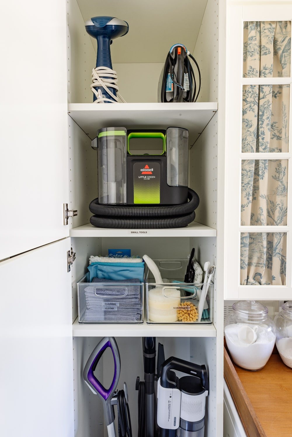 hidden diy broom cupboard and cleaning supply storage in a laundry room