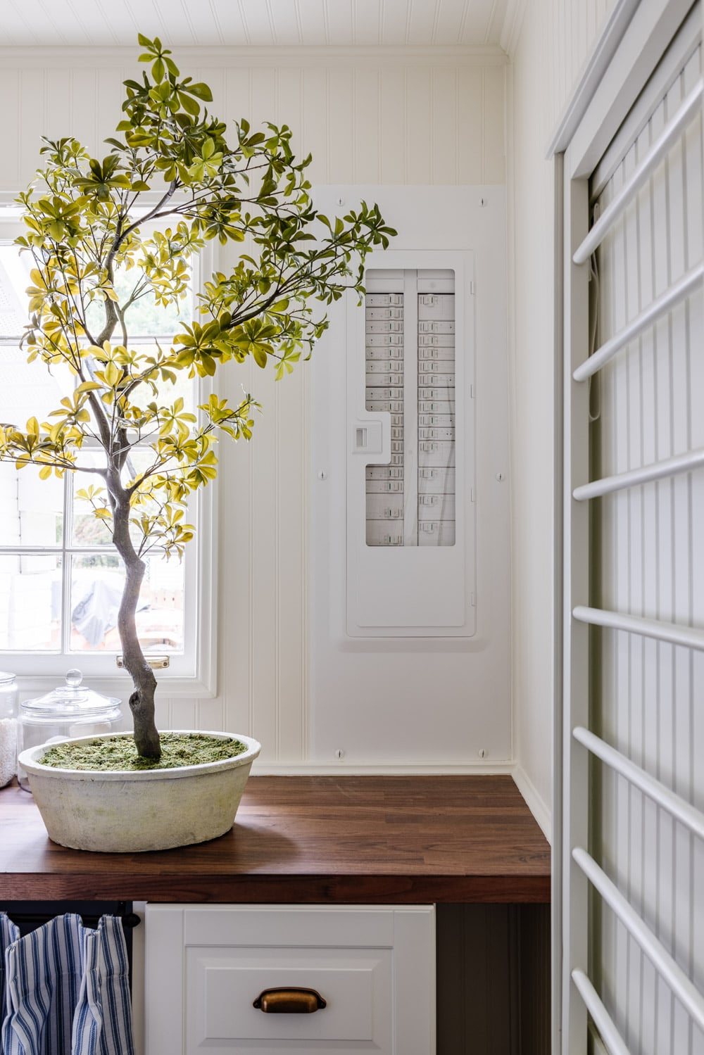 small laundry room organization - aesthetic electrical panel box