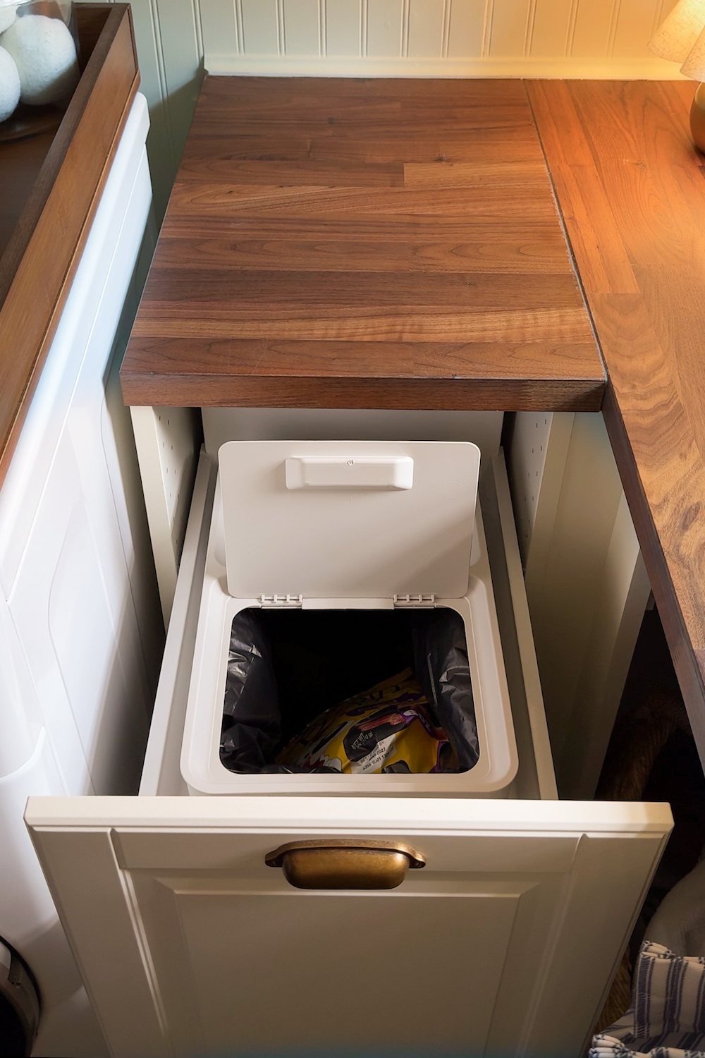 small laundry room organization - pull out trash can