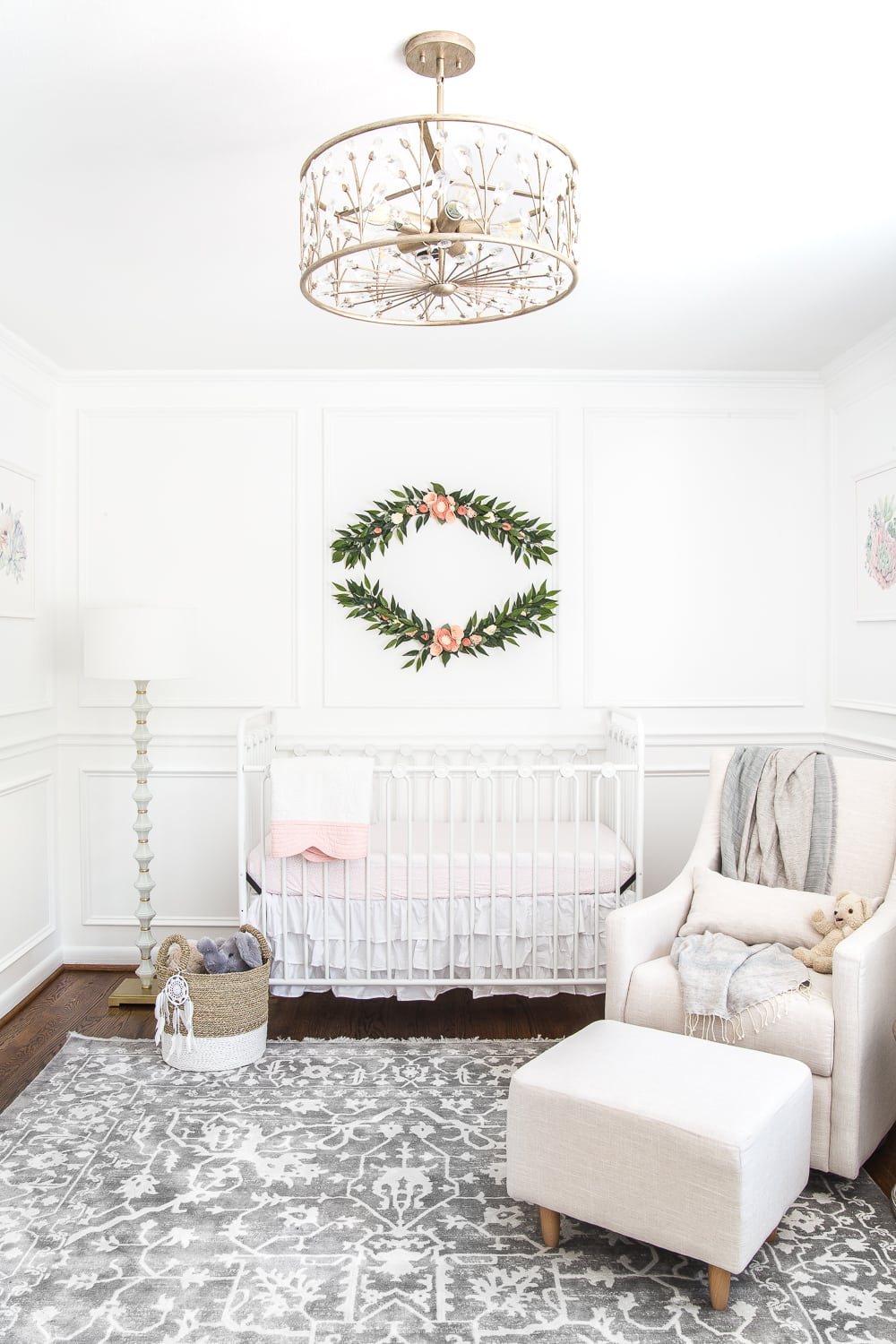 An all white nursery makeover room reveal with classic, vintage style furniture, Anthropologie-inspired patterns and textures, and floral accents.