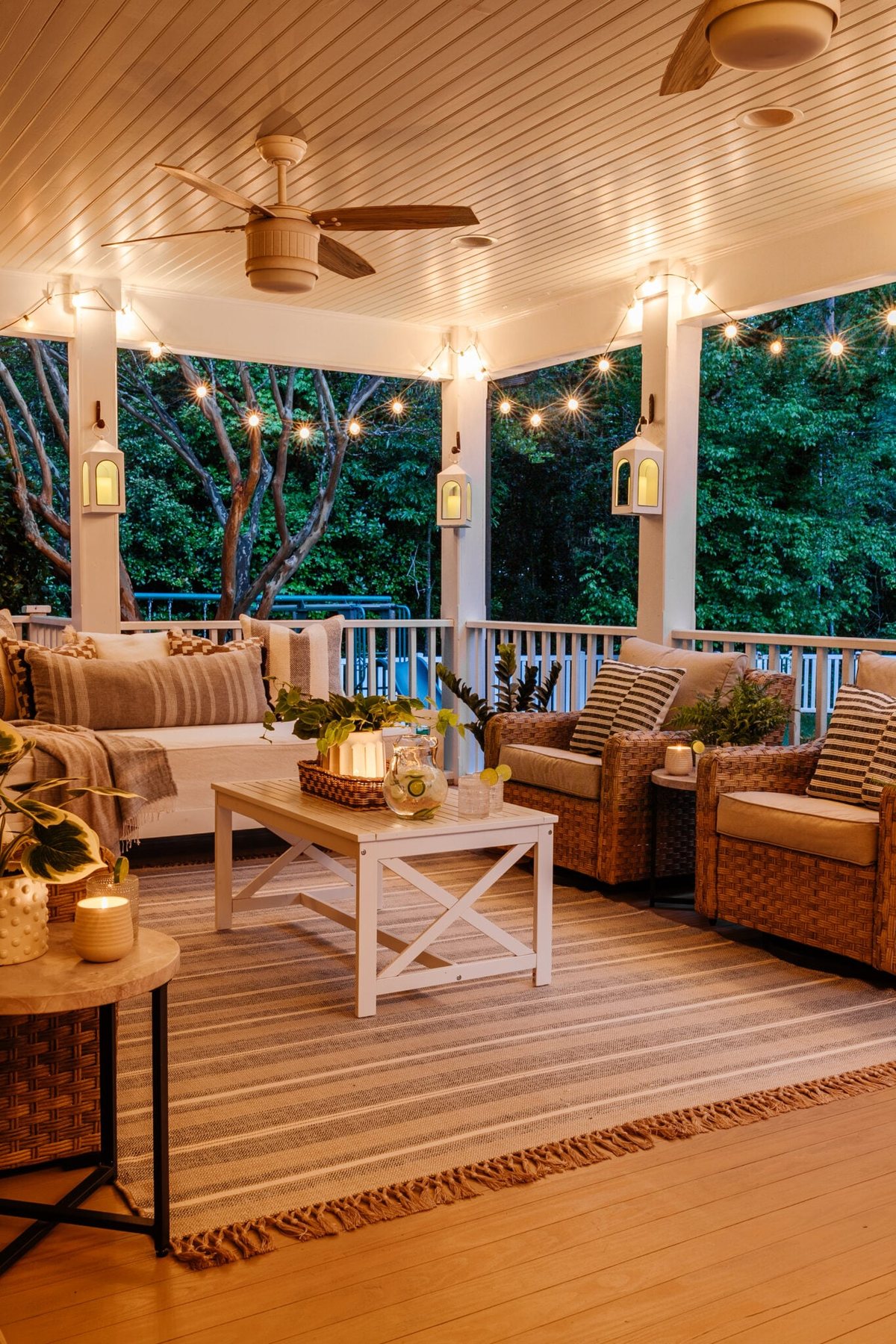 back porch conversation set with string lights and lanterns at night