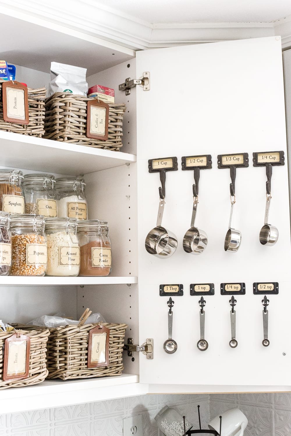 Pantry Cabinet Organization and Free Printable Label Set | unigumushane.com - A cabinet gets a drastic organization makeover using inexpensive IKEA jars / baskets, hanging storage, and a free pantry label printable set. #organization