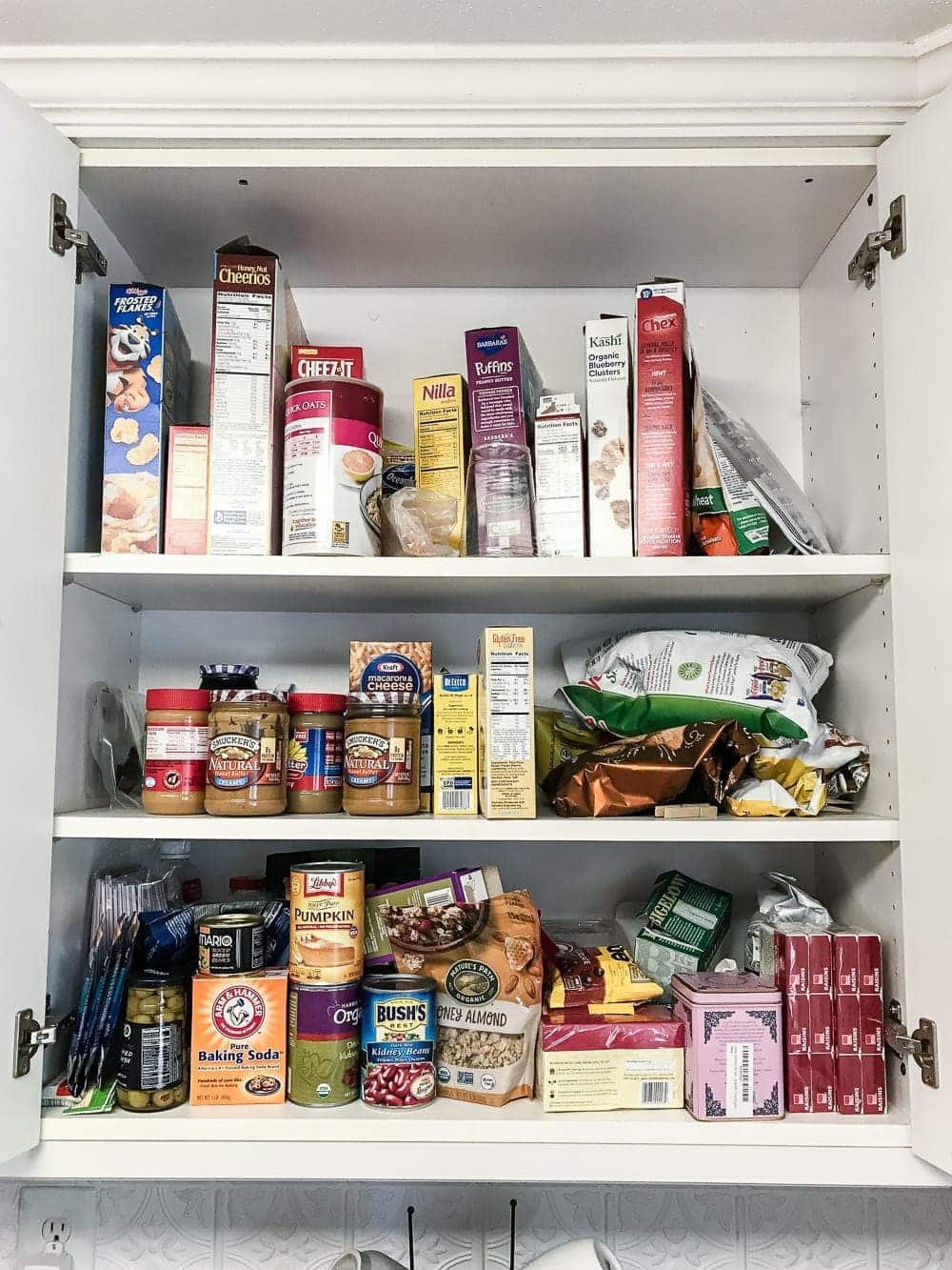 Pantry Cabinet Organization and Free Printable Label Set | unigumushane.com - A cabinet gets a drastic organization makeover using inexpensive IKEA jars / baskets, hanging storage, and a free pantry label printable set. #organization