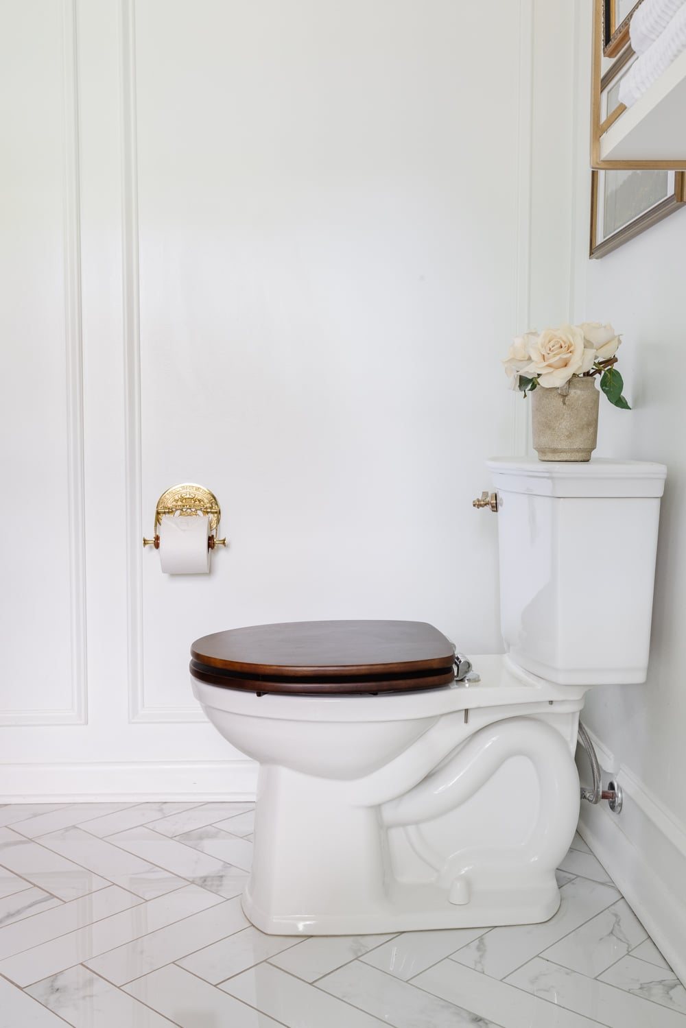 toilet with wooden seat and brass toilet paper holder