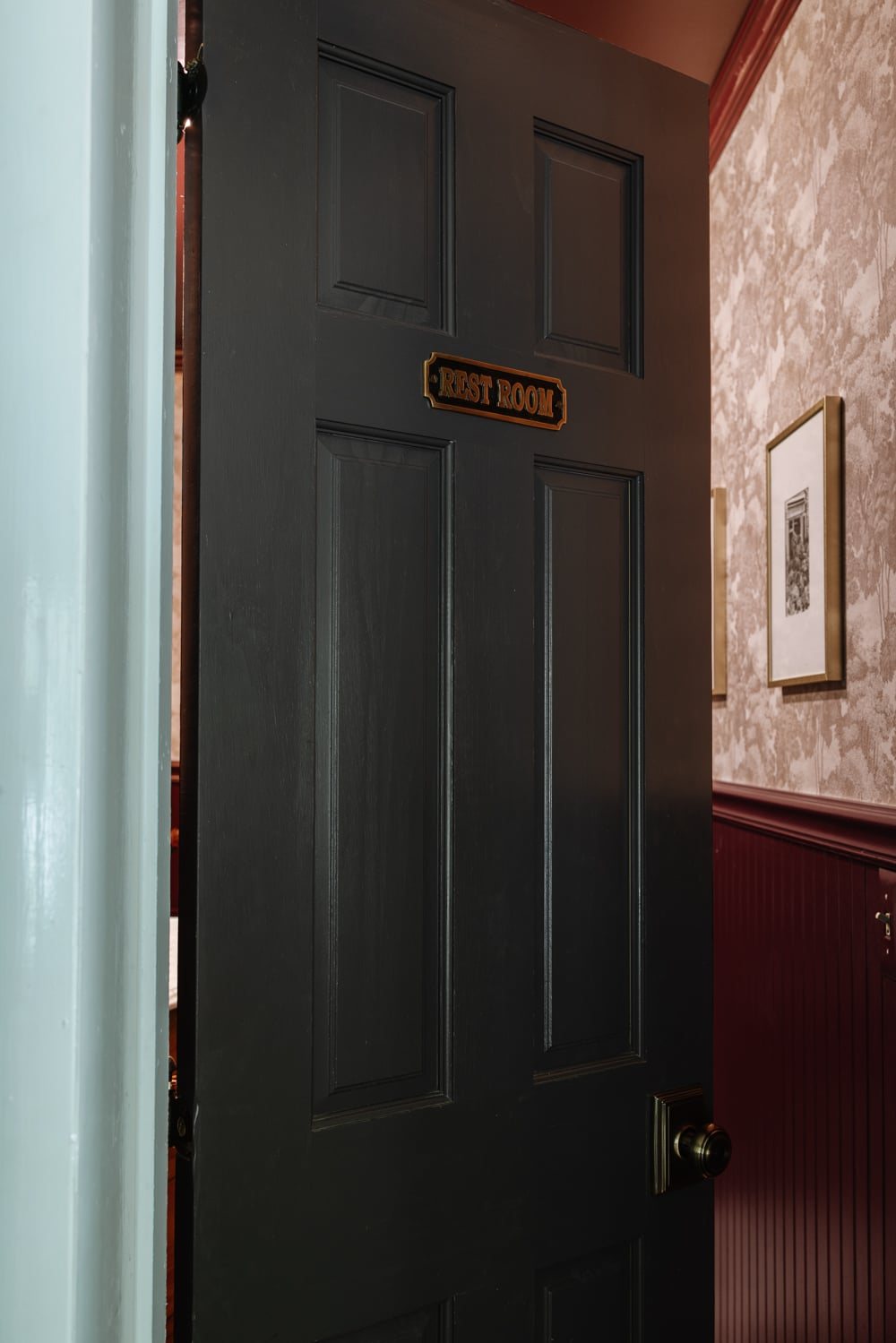 antique brass bathroom sign on door at home