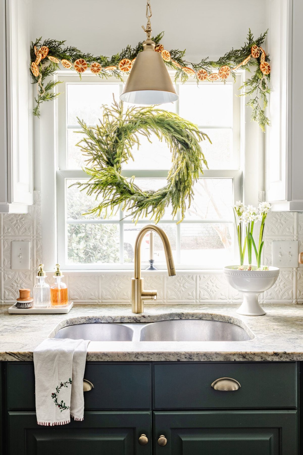 wreath and garland with dried oranges on a kitchen window